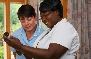 Two hospice nurses working in a hospice