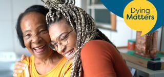 Grandmother and granddaughter hugging and laughing