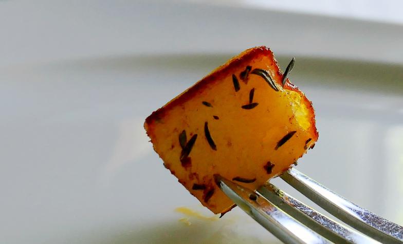 A stock photo of a roast potato on a fork