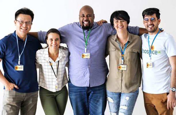 A group of people with Hospice UK clothing and badges