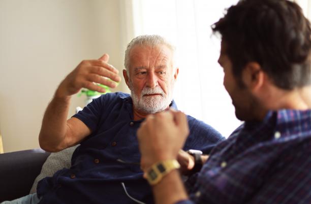 Older man and younger man talking