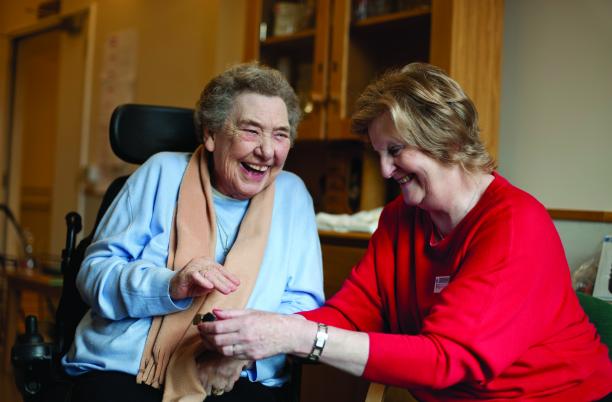 Older woman with in wheelchair with nurse