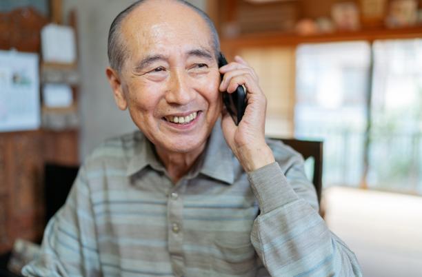 Older Asian man on phone