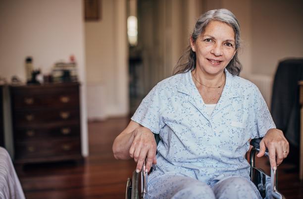Women in wheelchair smiling at the camera