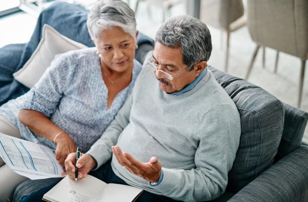 Elderly couple writing a will together