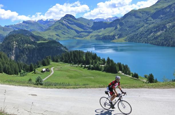 Geneva to Nice Cycle event participant with lake and mountain views