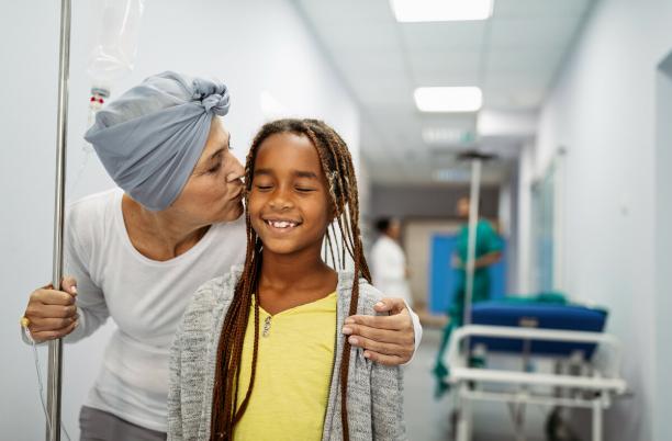 Woman in hospital kissing a young girl
