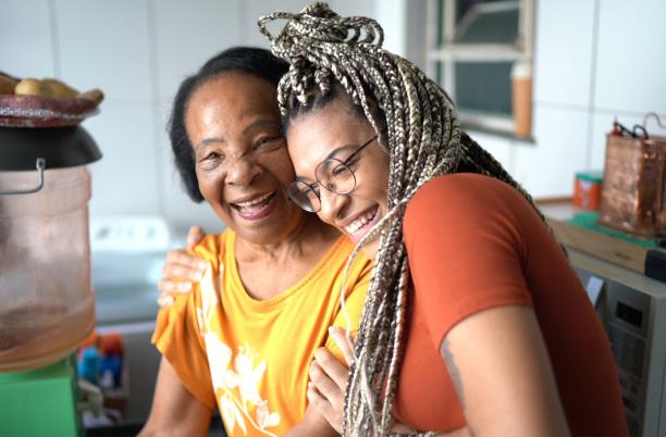 Grandmother and grandaughter hugging at home