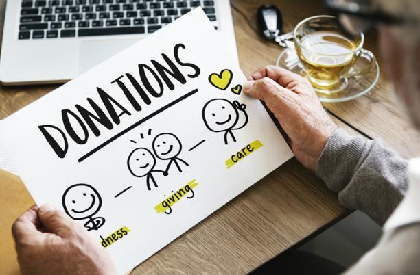 A stock image of someone looking at a sheet promoting donations