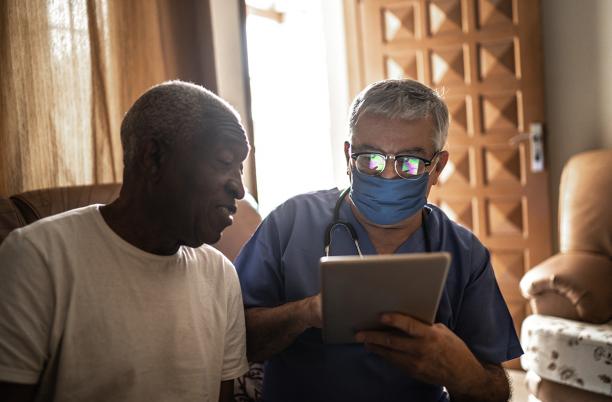 Man talking to his doctor at home