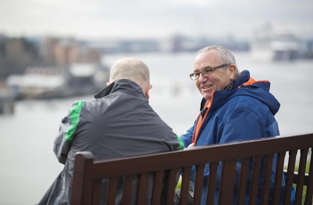 Two men talking on a bench