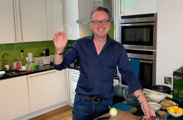 Lawrence Keogh in kitchen with book