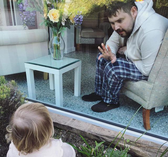 Tom, waving to his daughter Poppy at St Luke's Hospice in Plymouth