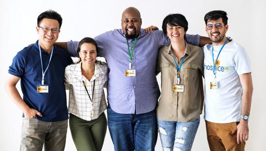 A group of people with Hospice UK clothing and badges