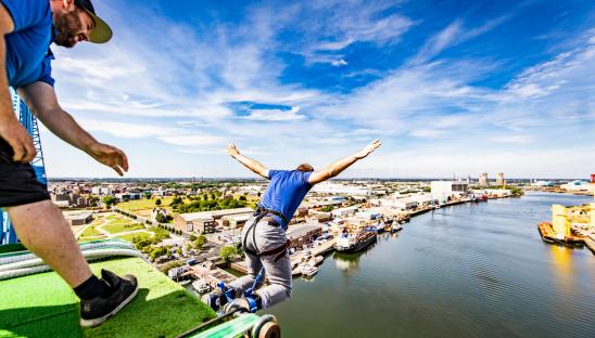 Someone taking part in a bungee jump event