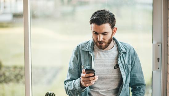 A stock photo of someone using a mobile phone