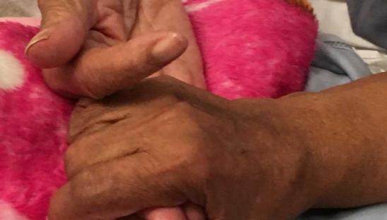 Maureen's parents holding hands